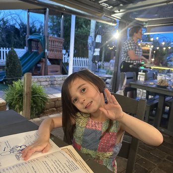 Aunt Catfish's - Patio seating by the water, playgrounds, and stage with live music playing. - Southern Near Me - Port Orange, Florida