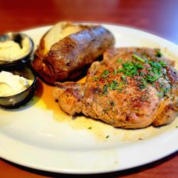 Ruby Tuesday - 12 ounce ribeye steak with baked potato, butter, and sour cream.