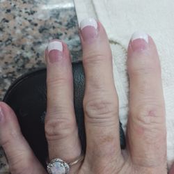 True Touch Nails Spa - Who messes up a simple French gel manicure? Zoom in to take a look at the cuticles and rough texture. The tips are excessively wide.