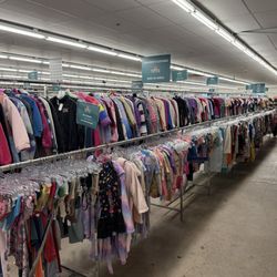 Bargain Thrift Store - Children's clothing racks. Every item has a color tag, and a new color marks down every other Sunday.