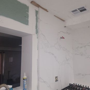 Amazing Kitchen and Stone - Unfinished backsplash with cardboard. Opening for cooktop too small. - Kitchen Supplies Near Me - Hempstead, New York