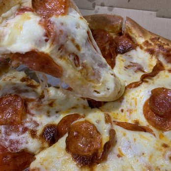 Chicago Connection - El Dorado - a hand holding a slice of pepperoni pizza - Pizza Near Me - Meridian, Idaho Chicago Connection - El Dorado - a hand holding a slice of pepperoni pizza - Pizza Near Me - Meridian, Idaho