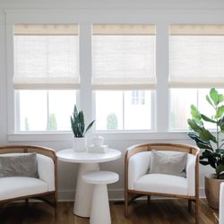 Budget Blinds of Mequon - Light-filtering woven shades in soft neutrals, bringing warmth and texture to a bright sitting nook.