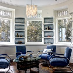 Arteriors - Custom ombre strie finish on library wall shelving in shades of blue with silver.