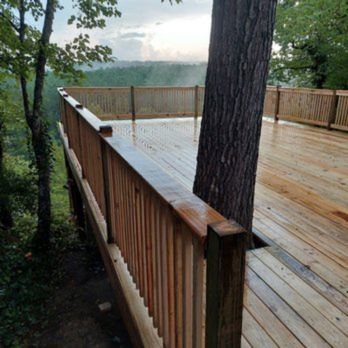 CD Construction - a view of a deck with a tree in the foreground - Decks & Railing Near Me