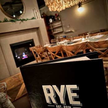 Rye - a dining room with a fireplace and dining table - Comfort Food Near Me - Appleton, Wisconsin Rye - a dining room with a fireplace and dining table - Comfort Food Near Me - Appleton, Wisconsin