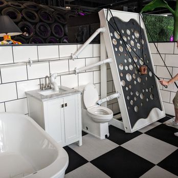 The Fat Putter - a man standing in front of a toilet - Mini Golf Near Me - Omaha, Nebraska The Fat Putter - a man standing in front of a toilet - Mini Golf Near Me - Omaha, Nebraska