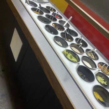Paleteria - a row of bowls of food on a counter - Mexican Near Me - Paducah, Kentucky Paleteria - a row of bowls of food on a counter - Mexican Near Me - Paducah, Kentucky