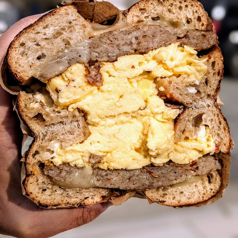 Transfer Co. Food Hall - Zataar Egg Bagel (add white cheddar/sausage) from Benchwarmers Bagels - Food Court Near Me - Raleigh, North Carolina Transfer Co. Food Hall - Zataar Egg Bagel (add white cheddar/sausage) from Benchwarmers Bagels - Food Court Near Me - Raleigh, North Carolina