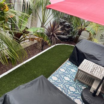 Cal Terra Design - a patio with a red umbrella - Landscaping Near Me Cal Terra Design - a patio with a red umbrella - Landscaping Near Me