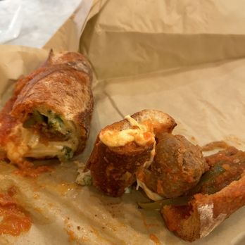 Salumi - meatball sandwich in mid consumption - Italian Near Me - Seattle, Washington Salumi - meatball sandwich in mid consumption - Italian Near Me - Seattle, Washington