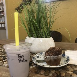 Taro bubble tea and a chocolate cupcake Taro bubble tea and a chocolate cupcake