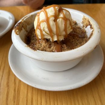 Simon Pearce - Pear cobbler with vanilla ice cream sprinkled with caramel sauce. - New American Near Me - Quechee, Vermont Simon Pearce - Pear cobbler with vanilla ice cream sprinkled with caramel sauce. - New American Near Me - Quechee, Vermont