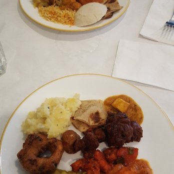 Priya Indian Restaurant - That thing to the left - looks like a donut - SO GOOD! It's like a fried pretzel w/cilantro in it. And great fried chicken! Awesome buffet! - Indian Near Me - Schaumburg, Illinois