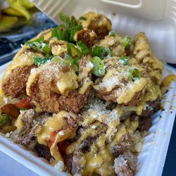 The Chillfactory - Surf & turf fries . Steak crab and prawns . I got garlic Parmesan prawns for an extra fee . Worth every penny the box couldn't even close !
