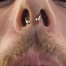 Crooked septum piercing. Crooked septum piercing.