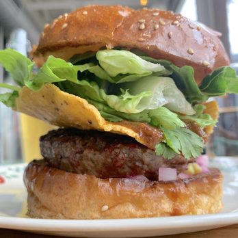 Odd Duck - Burger ($19): chili, beer cheese, tostada, broccoli-Brussels sprout slaw, aioli - American Near Me - Austin, Texas Odd Duck - Burger ($19): chili, beer cheese, tostada, broccoli-Brussels sprout slaw, aioli - American Near Me - Austin, Texas
