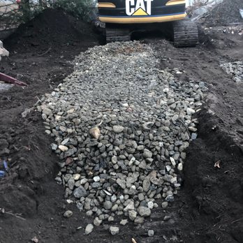 New England Tree Masters - This is a 2 Foot Trench filled with 2 Inch diamter stones - Tree Services Near Me - Boxborough, Massachusetts