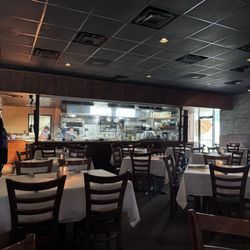 Victor's Wood Grill - Super bright kitchen and sunlight shining into the dark dining room