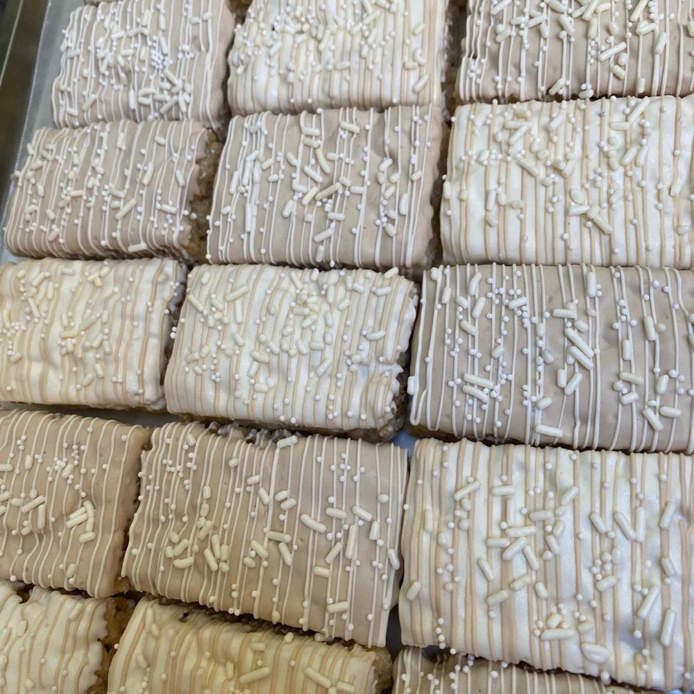Indulgence - a tray of cookies with white icing - Chocolatiers & Shops Near Me Indulgence - a tray of cookies with white icing - Chocolatiers & Shops Near Me