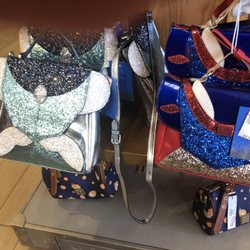Disney's Character Warehouse - Adorable purses. Dooney abd Bourke orange Bird print is on the bottom shelf.