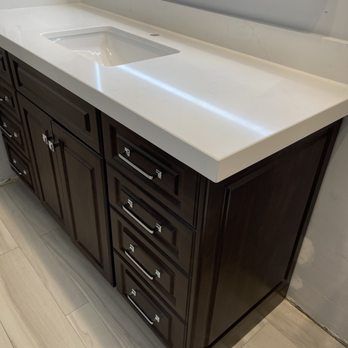 Cali Stone Artisans - Quartz countertop with backsplash cut around electrical outlet due to new, higher vanity. - Countertop Installation Near Me - Bellflower, California
