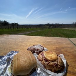 Sausage Egg and Cheese on a ciabatta roll, an apple fritter, raspberry muffin top with cream cheese over looking fern valley farm. Sausage Egg and Cheese on a ciabatta roll, an apple fritter, raspberry muffin top with cream cheese over looking fern valley farm.
