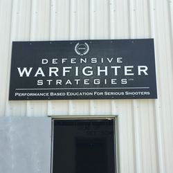 Defensive Warfighter Strategies - Front entrance with sign.