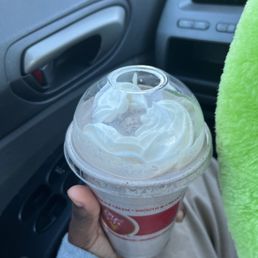 a hand holding a cup of ice cream a hand holding a cup of ice cream