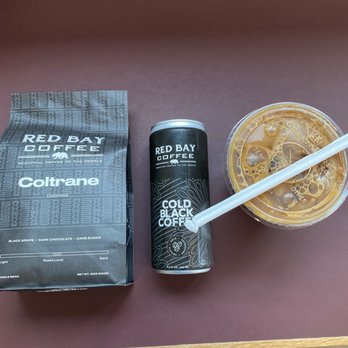 Red Bay Coffee - Freshly roasted bag of Coltrane (whole bean), can of "cold black coffee", and an iced vanilla latte made with oatmilk - Cafes Near Me - Oakland, California Red Bay Coffee - Freshly roasted bag of Coltrane (whole bean), can of "cold black coffee", and an iced vanilla latte made with oatmilk - Cafes Near Me - Oakland, California