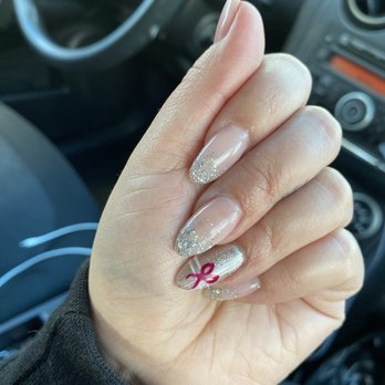 Megacare Nails & Spa - Nude with glitter tips and fun holiday bow. - Waxing Near Me - Arcadia, California