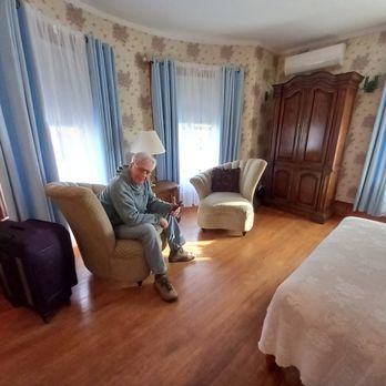 Derby Line Village Inn - a man sitting in a chair - Bed & Breakfast Near Me - Derby, Vermont Derby Line Village Inn - a man sitting in a chair - Bed & Breakfast Near Me - Derby, Vermont