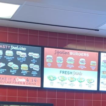 Apollo Burger - Menu - Multiple digital menu screens show food, drinks, and combo options at Apollo Burger in Lehi, UT. - Burgers Near Me - Lehi, Utah
