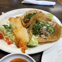La Familia - Carnitas taco (front) Al Pastor Taco (back). Requested w onion & cilantro. Tamale