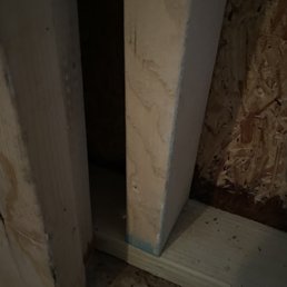 Water damage and mold 5-6" from ground due to lack of plastic barrier between concrete and garage
