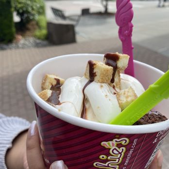 Menchie's Frozen Yogurt - a hand holding a cup of ice cream with a spoon - Ice Cream & Frozen Yogurt Near Me - Renton, Washington Menchie's Frozen Yogurt - a hand holding a cup of ice cream with a spoon - Ice Cream & Frozen Yogurt Near Me - Renton, Washington
