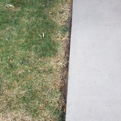 Precision Landscape and Maintenance - More inconsistent trimming/mowing. Sprinkler covered in dirt & leaves since it's not turned on.