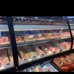 a variety of meats in a display case