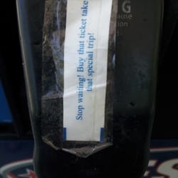 A fortune from a fortune cookie that someone taped to the gas pump.