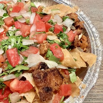 Chronic Tacos - Nachos. Al pastor, refried beans, cheese, onion, and cilantro on top of crunchy tortilla chips. - Mexican Near Me - Laguna Niguel, California Chronic Tacos - Nachos. Al pastor, refried beans, cheese, onion, and cilantro on top of crunchy tortilla chips. - Mexican Near Me - Laguna Niguel, California