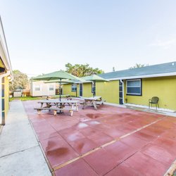 Healing Properties Sober Living - Shared courtyard with shaded picnic tables at our men's sober living home in Delray Beach.