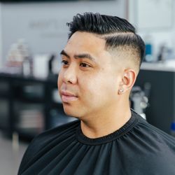 Andy's Cuts - Pompadour with high skin fade and hard part line. Precision men's haircut by Andy's Cuts in Huntington Beach, CA.
