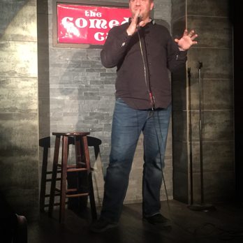 The Comedy Cave - a man speaking into a microphone - Comedy Clubs Near Me - Calgary, Alberta The Comedy Cave - a man speaking into a microphone - Comedy Clubs Near Me - Calgary, Alberta