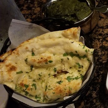 Kathmandu Kitchen - Garlic naan and Chicken Palak (the green dish is an entree size) - Indian Near Me - Cary, North Carolina