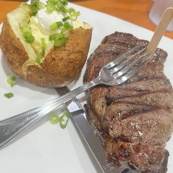 Sizzler - Rib Eye (14 oz) w/ Baked Potato (sour cream, butter & onions) - Seafood Near Me - Culver City, California Sizzler - Rib Eye (14 oz) w/ Baked Potato (sour cream, butter & onions) - Seafood Near Me - Culver City, California