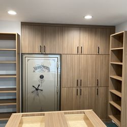 Ideal Customs - Cabinets were custom built to fit around a safe for a built in look.