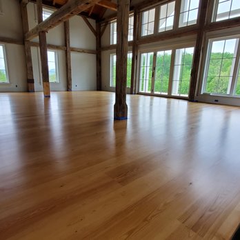 Baxter Floors - a large room with wood floors - Flooring Near Me
