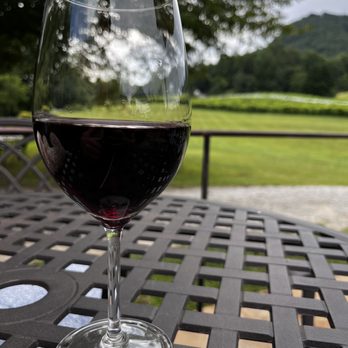 Tiger Mountain Vineyards - a glass of wine on a table - Wine Tours Near Me - Tiger, Georgia Tiger Mountain Vineyards - a glass of wine on a table - Wine Tours Near Me - Tiger, Georgia