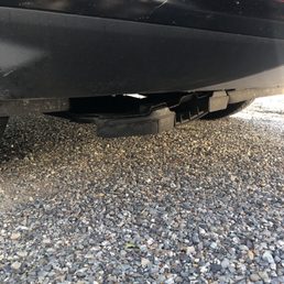 Hanging, unsecured splash guard after oil change Hanging, unsecured splash guard after oil change