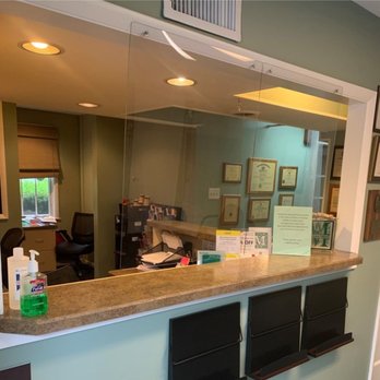 McKenna Dental - Reception desk in a dental office with a glass wall, featuring a welcoming atmosphere for patients. - General Dentistry Near Me - Allentown, Pennsylvania McKenna Dental - Reception desk in a dental office with a glass wall, featuring a welcoming atmosphere for patients. - General Dentistry Near Me - Allentown, Pennsylvania